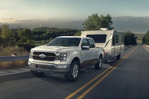 White 2021 Ford F-150 Pulling Trailer on Road