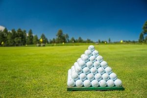 golf balls stacked in a pyramid on a gold course
