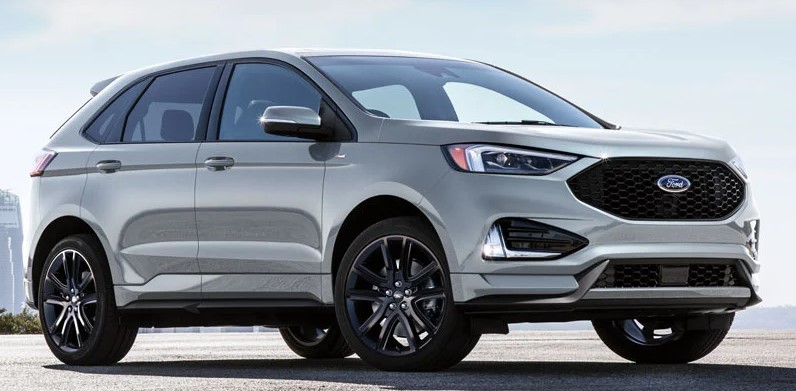 Silver 2021 Ford Edge Parked in front of  city view.