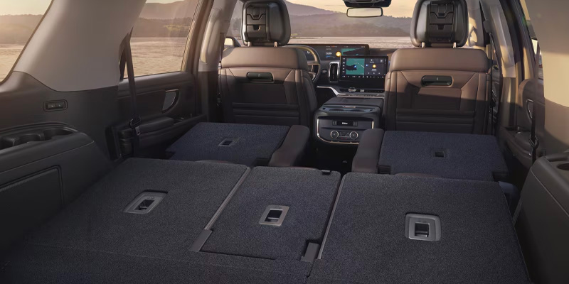 Interior of a 2025 Ford Expedition SUV with rear seats folded flat, showing space for cargo.